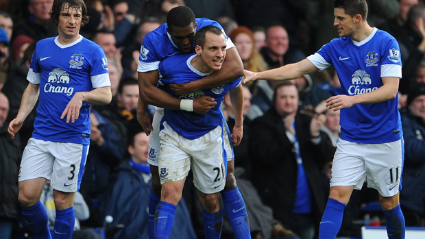 Leon Osman is congratulated by his Everton team-mates after scoring against Manchester City